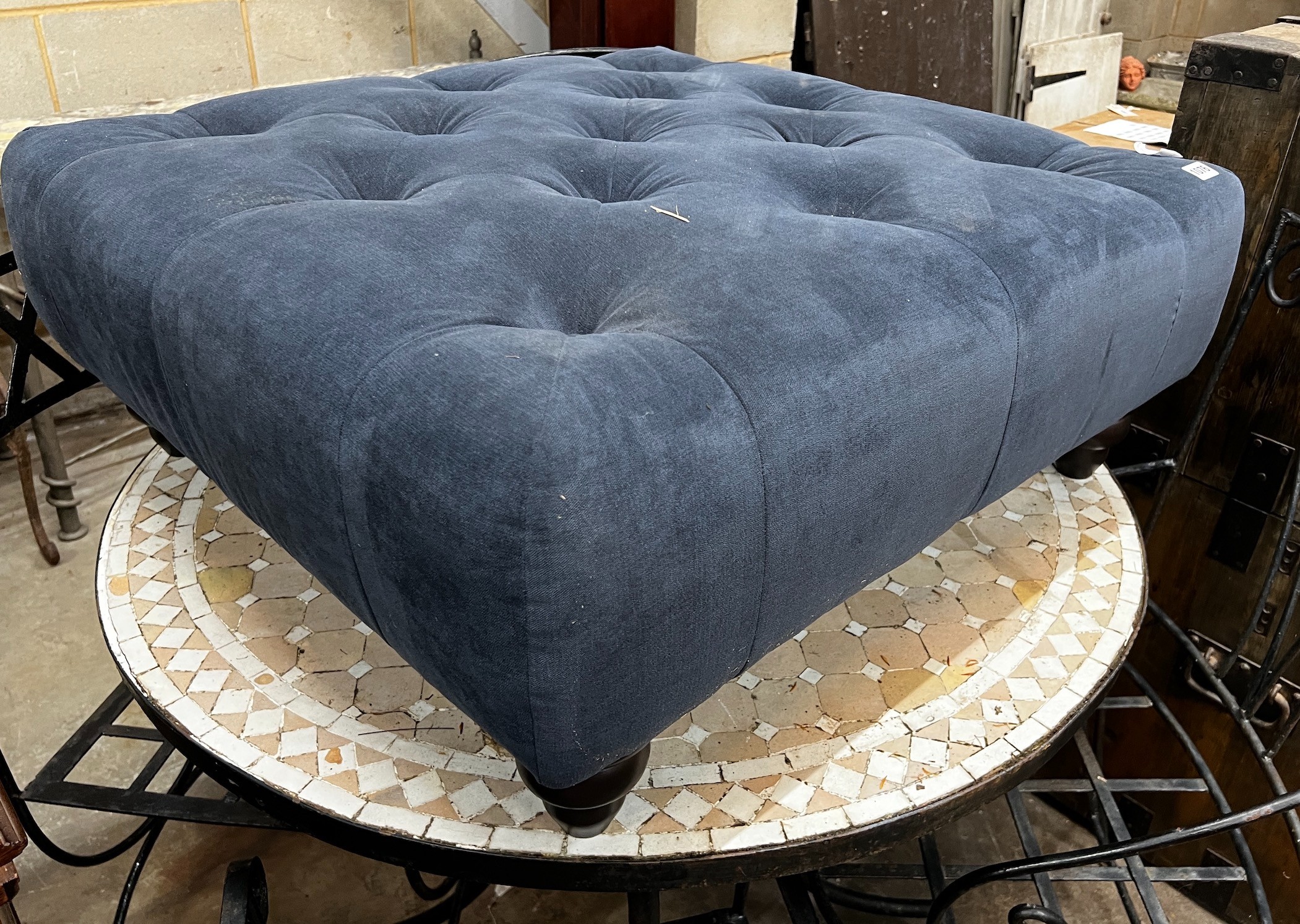 A contemporary buttoned blue fabric footstool, 80cm square, 33cm high